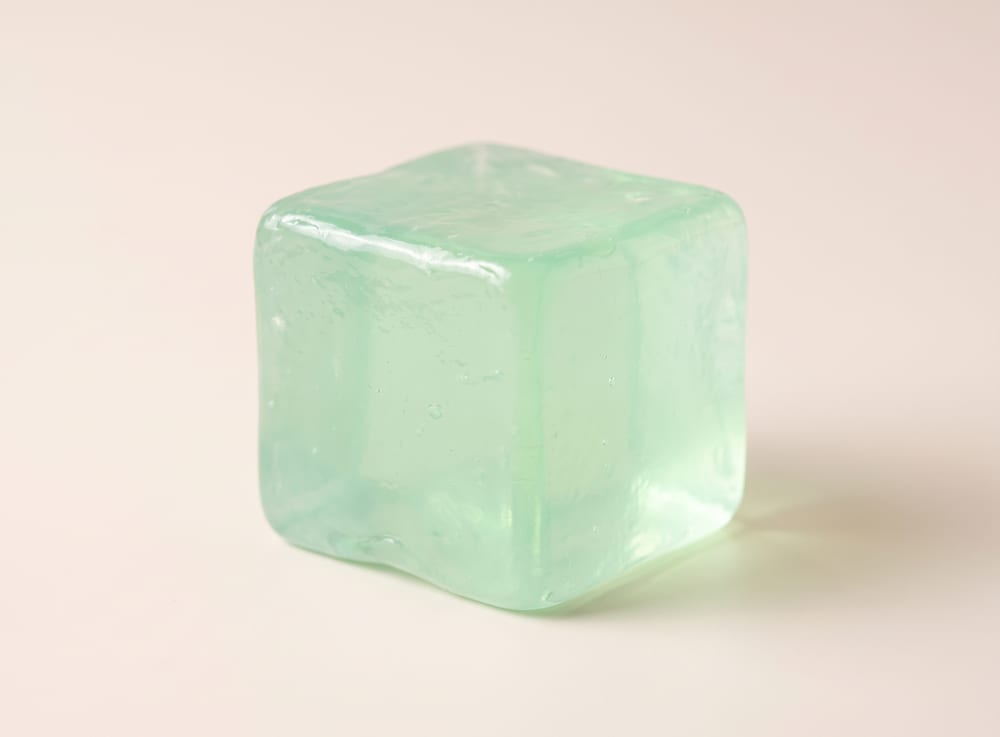 A single translucent mint-green squishy soap cube.
