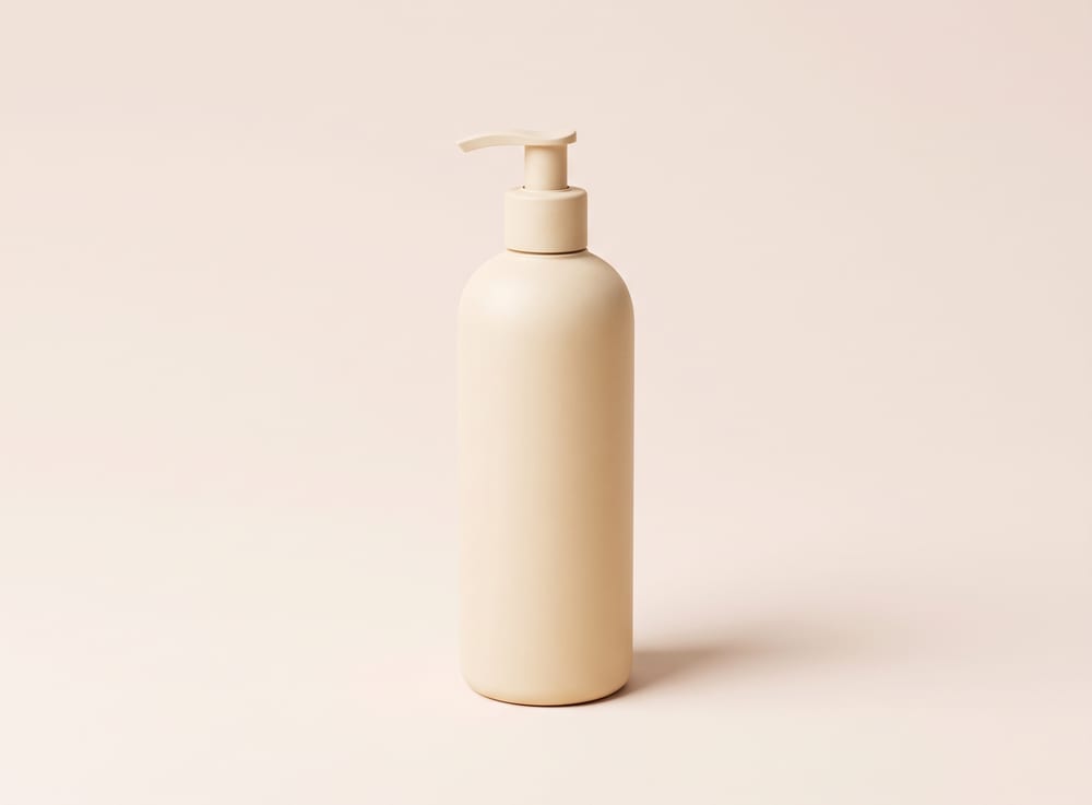 A tall matte cream pump bottle of hair wash.
